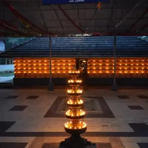 Temple entrance with traditional oil lamp (deepam) lit at the doorway